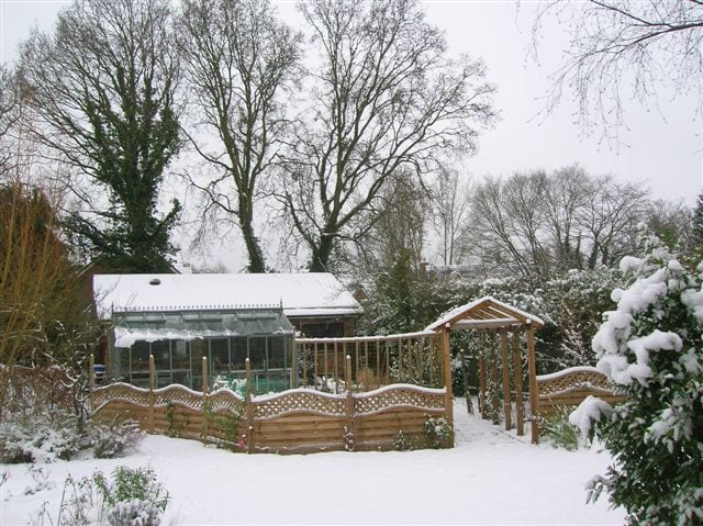 Traditional greenhouse in the snow